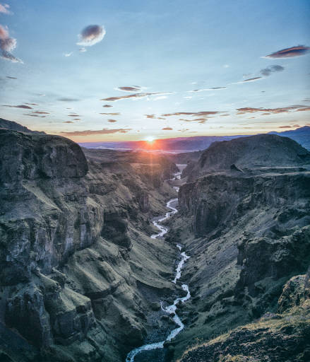 Deep valley with a small river at the bottom.